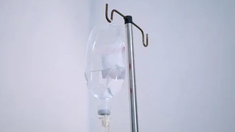 Close up view of saline IV drip bag and Infusion pump hanging on stainless .. Stock Footage 281576211