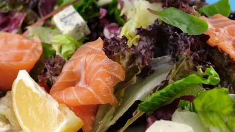 Close-up view of Salmon fish salad with cheese on blue chroma key Stock Footage 78667893