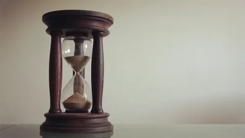 Close view of sand flowing through an old hourglass with copy space Stock Footage 80427460