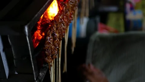 Close up view of Sate or satay, traditional food from Indonesia is being ro.. Stock Footage 294277120
