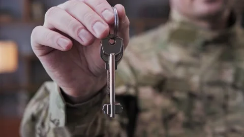 Close up view of satisfied man soldier holding key in hands State support. Stock Footage 172398158