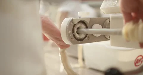 Close view of a sausage filling machine during production, Meat Processing Plant Stock Footage 340007923