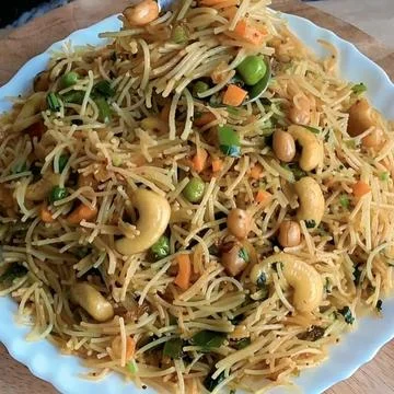 Close up view of savory roasted vermicelli bath with crunchy nuts and carrots Stock Photos