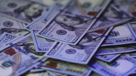 Close-up view of scattered hundred dollar bills showing detailed designs, Stock Footage 327698905