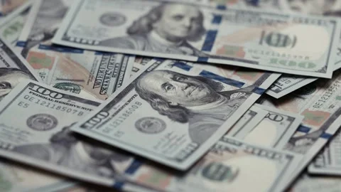 Close-up view of scattered US dollar banknotes showing detailed designs and Stock Footage 327698848
