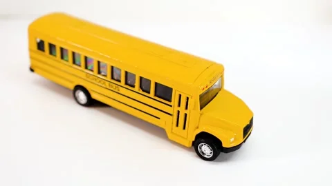 Close up view of school bus toy on white background, back to school concept. Video stock 282912159
