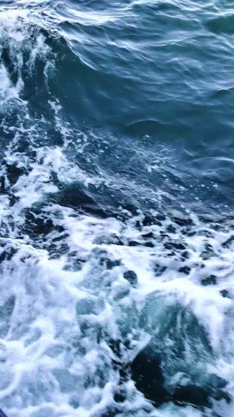 Close up view of sea waves created by a boat as it moving through the blue sea. Stock Footage 297280217