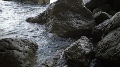 Close view sea waves splash around wet brown coastal rocks Video stock 102664629