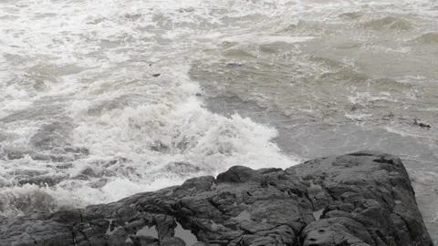 Close view of sea waves striking large rocks Stock Footage 191388357
