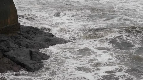 Close view of sea waves striking large rocks 動画素材 191414666