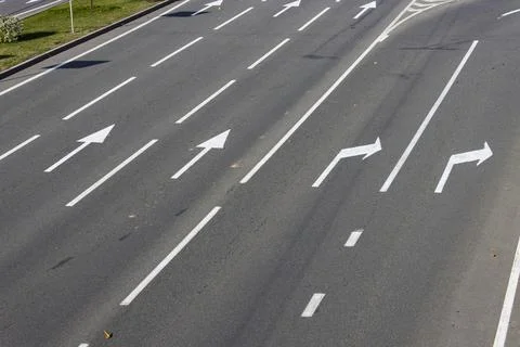Close-up view of a section of a multi-lane freeway and its exit. Road marking Stock Photos