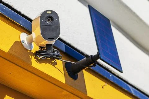 Close up view of security camera with solar panel mounted on villa wall. Sweden. Stock Photos