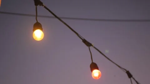 Close up view with selective focusing to the light bulb with sunset sky in .. Video stock 246467451