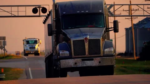 Close view of a semi truck passing the railroad crossing at dusk 스톡 동영상 345530623