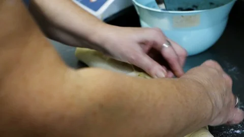 Close up view of senior lady�s hands rolling a poppy seeds roll. Sweets Stock Footage 99360333