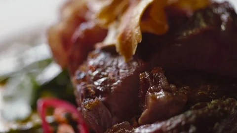 Close up view of a served roasted meat on the plate. Delicious food. Stock Footage 74624037