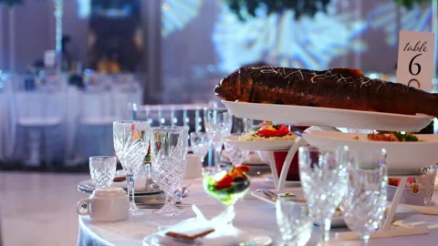 The close up view of served table with glasses, plates, and fish at the Stock Footage 330986207