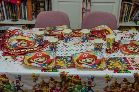 Close-up view of served table with Mario theme decoration prepared for party. Fotos de archivo