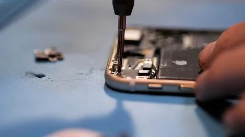 Close view serviceman screws iphone antenna with screwdriver Stock Footage 104655763