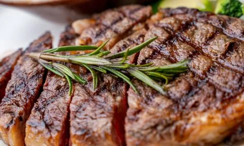 Close up view on serving of marinated grilled rib eye steak with baked potato Photos