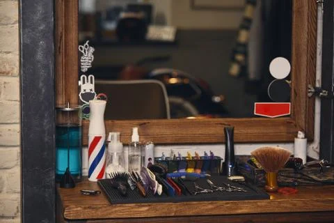 Close-up view of set of professional barber tools on wooden shelf in barbershop Stock Photos
