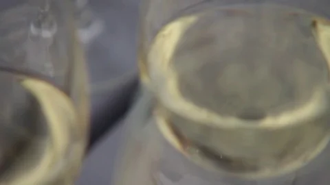 Close-up view on set of transparent glasses with white wine. Slow motion. Stock Footage 72603236