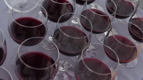 Close-up view on set of transparent glasses with red wine. Slow motion. Video stock 72603253
