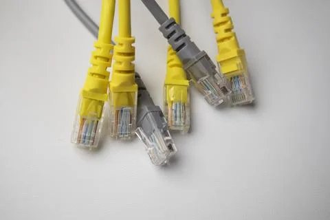 Close-up view of several Ethernet network cable connectors in yellow and gr.. Stock Photos