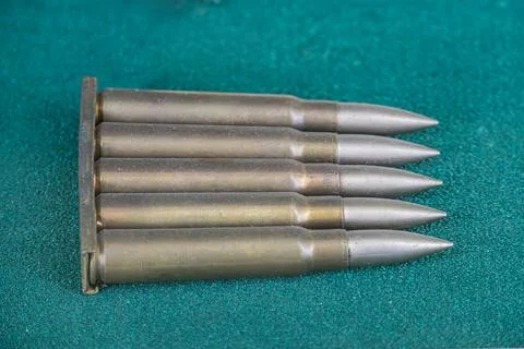 Close-up view of several metallic bullet casings, arranged in a fan pattern o Stock Photos
