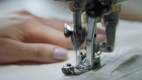 Close up view of sewing machine operation. Needle with thread sew white fabric Stock Footage 194580740