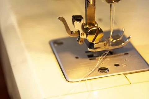 Close up view of sewing process. Female hands stitching white fabric on Stock Photos