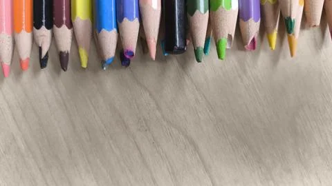 Close-up view of sharpened colored pencils on wooden desk. Ideal image for .. Stock Photos