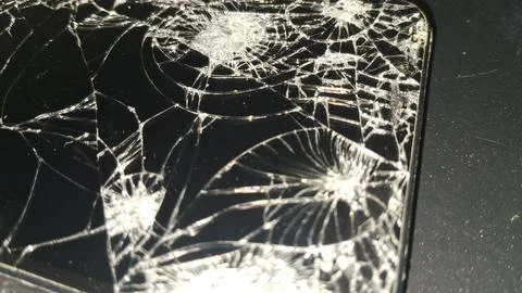 Close up view of a shattered black smartphone screen display Stock Photos