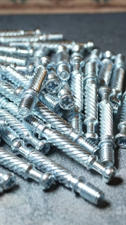 Close-up view of shiny metal screws on a dark surface Stock Footage 316939352