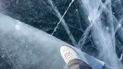 Close up view of shoe skating on the ice of frozen Baikal. Blue transparent ice Stock Footage 170592580