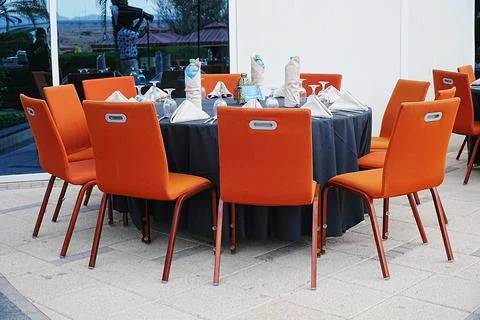 Close view shot of Iftar buffet Table setting, with table and orange chairs Stock Photos