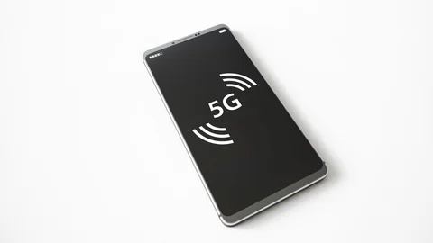 Close view shot of smartphone screen showing flashing 5g symbol. 動画素材 119184641