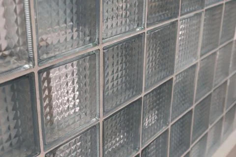 A close-up view showcases a cluster of clear glass blocks arranged in a gri.. Stock Photos