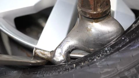 Close-up view showing rusty brake caliper connected to white alloy wheel Stock Footage 347902524