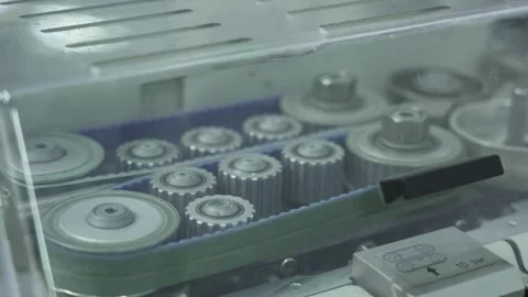 A close-up view shows a cable feeding mechanism with multiple metal rollers Stock Footage 321896791