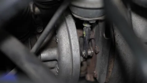 A close-up view shows a car engine turbocharger housing with its actuator rod Stock Footage 345108527