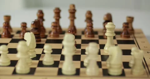 Close view shows chess pieces on wooden board. Players make strategic chess Stock Footage 335065860