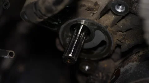 A close-up view shows an exposed splined shaft extending from a greasy and di Video stock 345108997