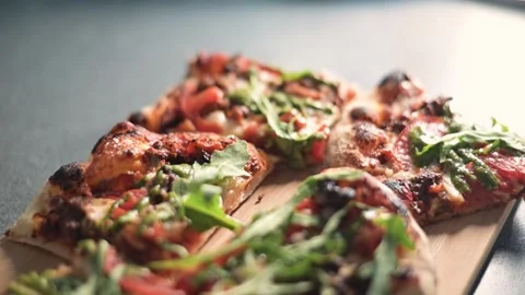 A close-up view shows a freshly made pizza topped with vegetables and herbs Stock Footage 339005356