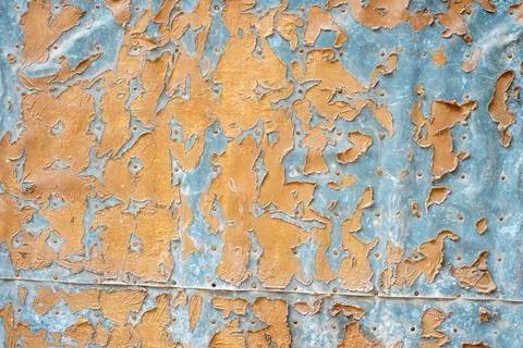 A close-up view shows a wall with old paint that is chipped and peeling Stock Photos