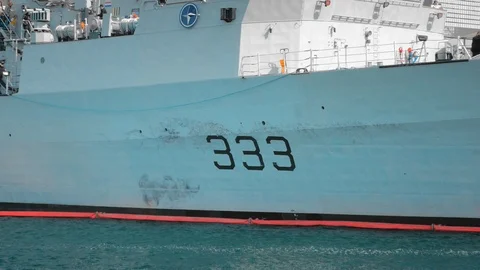 Close-up view of the side of a NATO warship with tail number 333. Unidentified Stock Footage 119387265