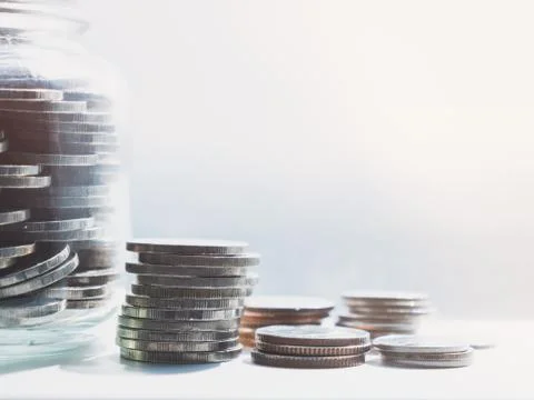 Close up view on the side, saving the full silver coin in the glass bottle Stock Photos