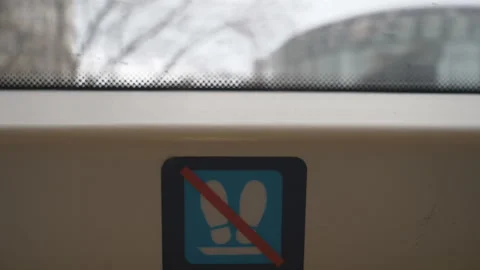 A close up view of a sign ‘don’t put your feet’ in a moving train. Stock Footage 146717530