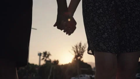 Close up view of silhouette of hands joining together with sunset on the Stock Footage 204850693
