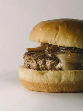 Close up view of Single cheese burger with caramalised onions Stock Photos